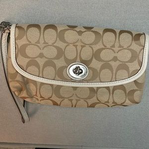 Vintage coach wristlet in a cream and white color
